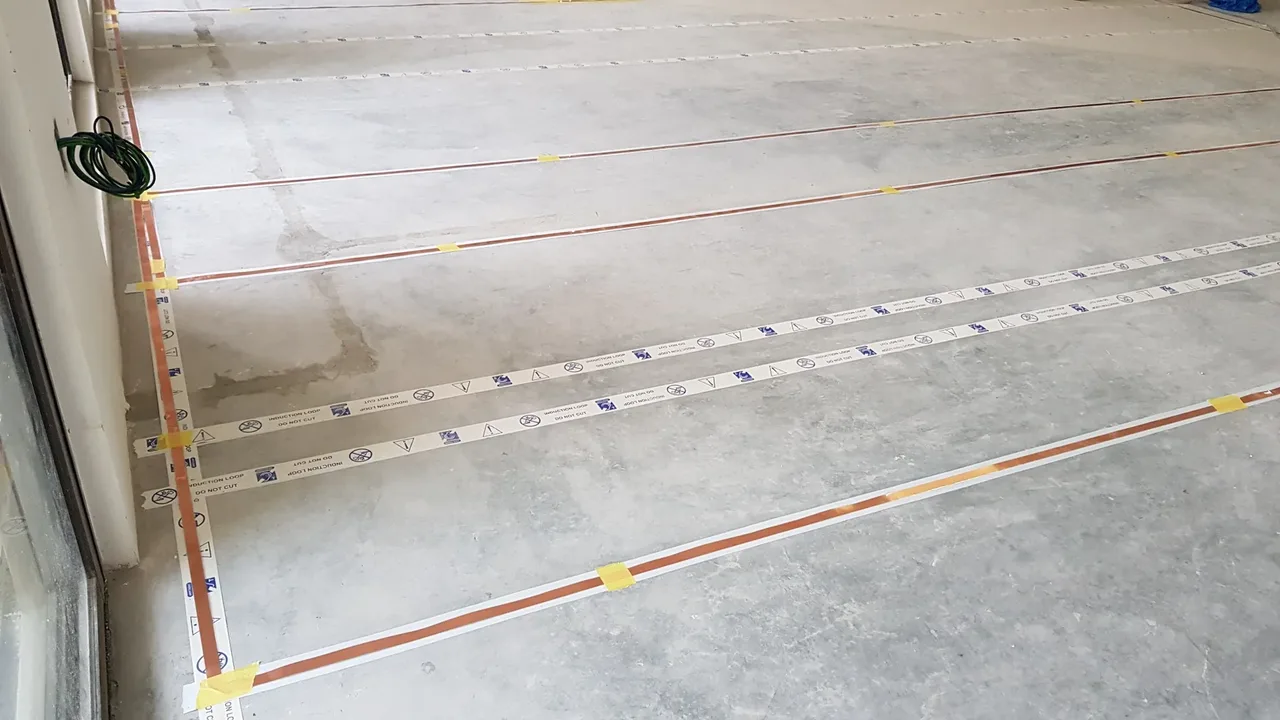 PNSS Ampetronic flat copper tape MultiLoop installation before floor finishes at a higher-education facility in Johor