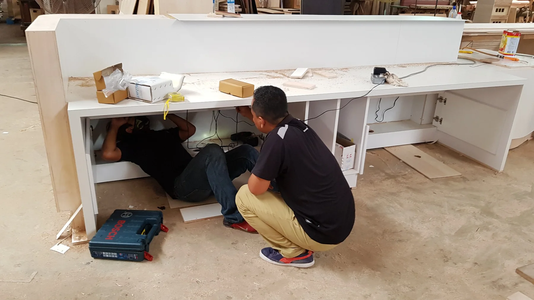 PNSS installing an Ampetronic CLD1 counter hearing loop at a reception desk in Malaysia