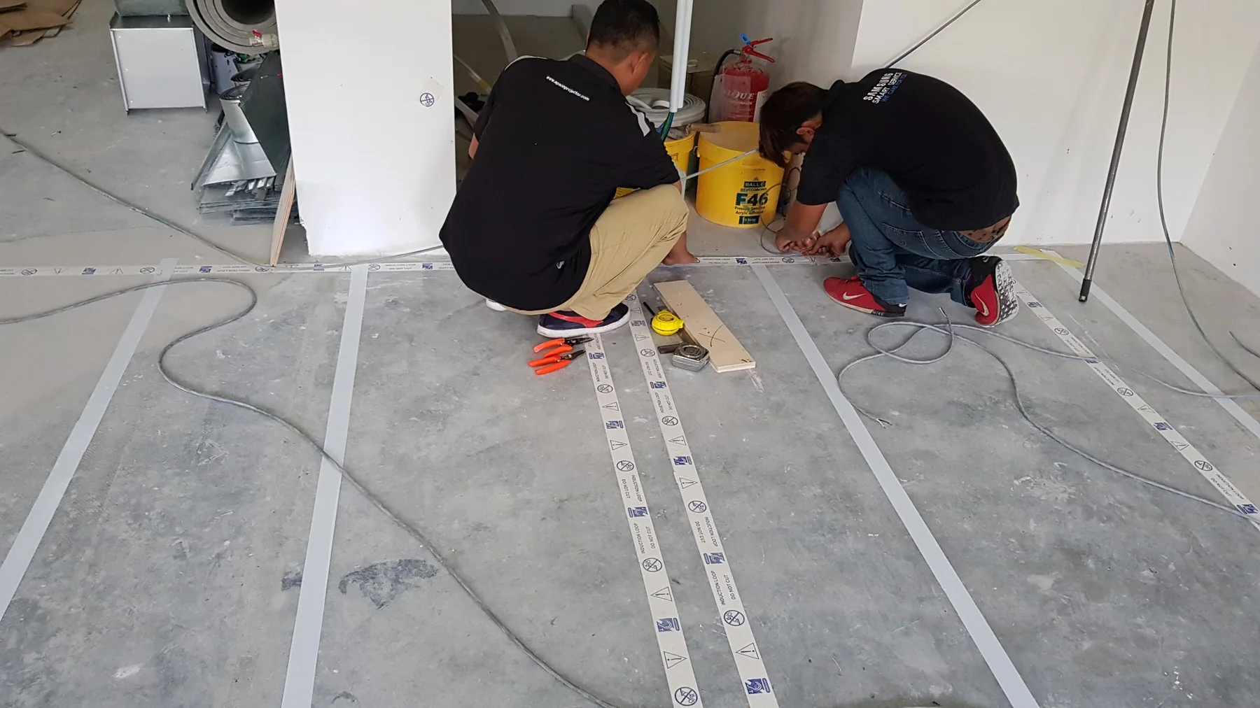 PNSS technicians installing Ampetronic hearing-loop conductors in Johor Malaysia